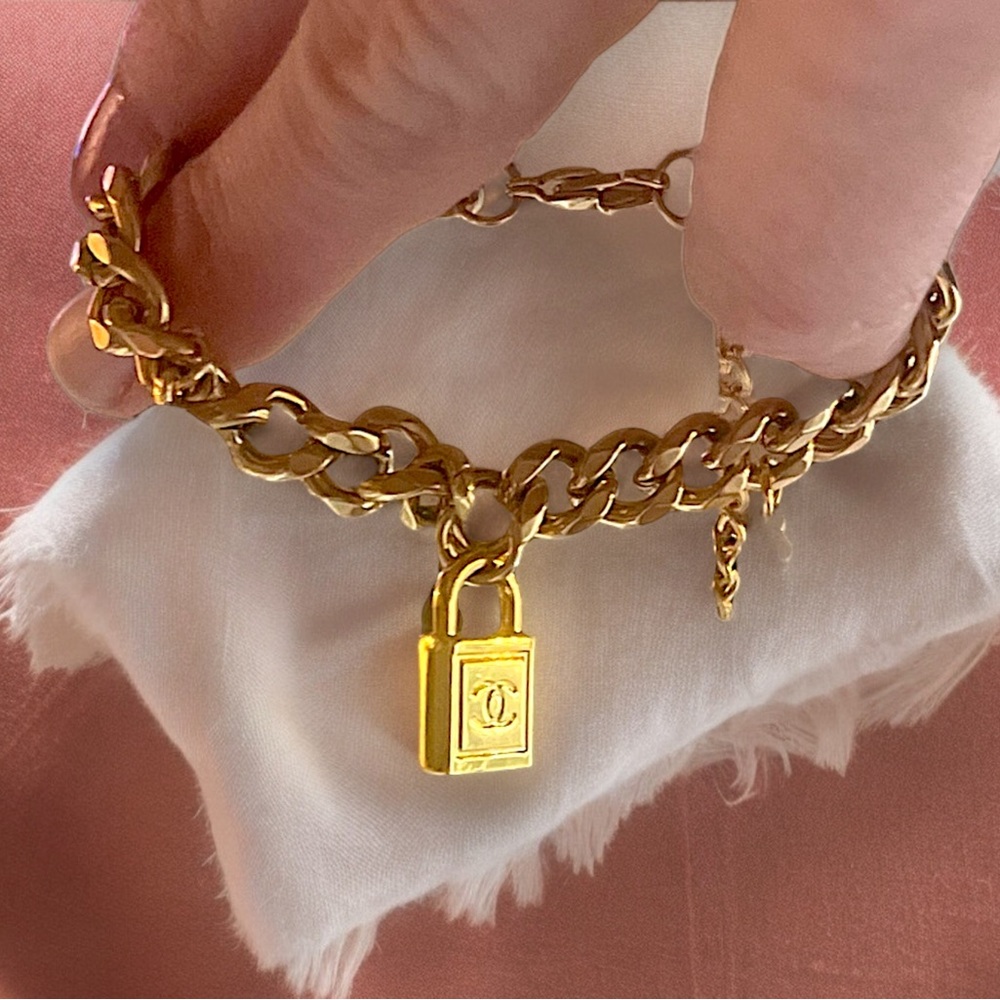 Repurposed vintage Chanel padlock attached to an 18k gold plated bracelet